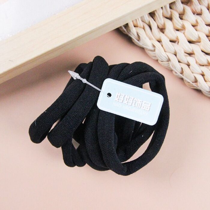 Eight black cotton rubber bands